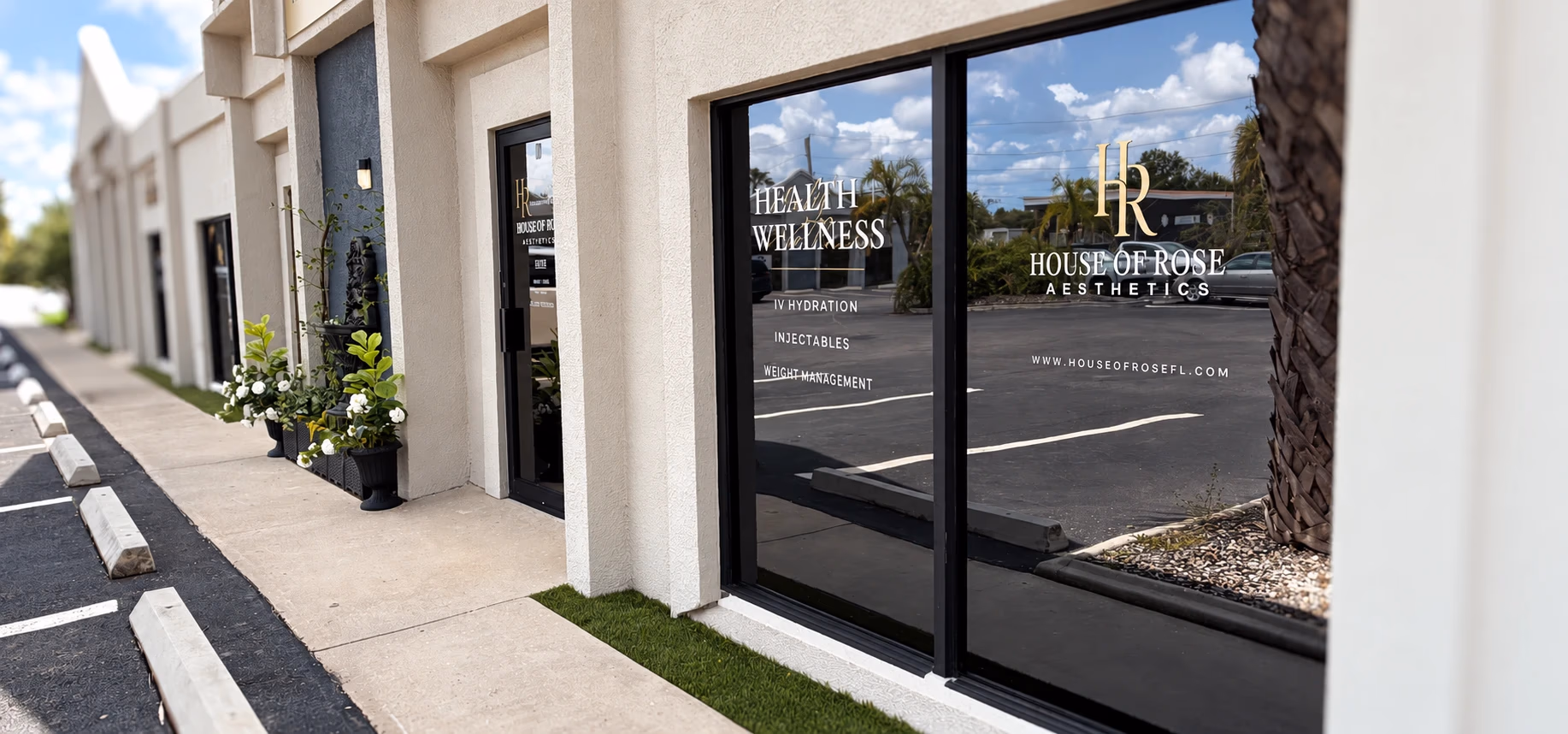 The House of Rose storefront on Olympia Avenue, with cream walls, a black-framed entrance, and gold HR window lettering.